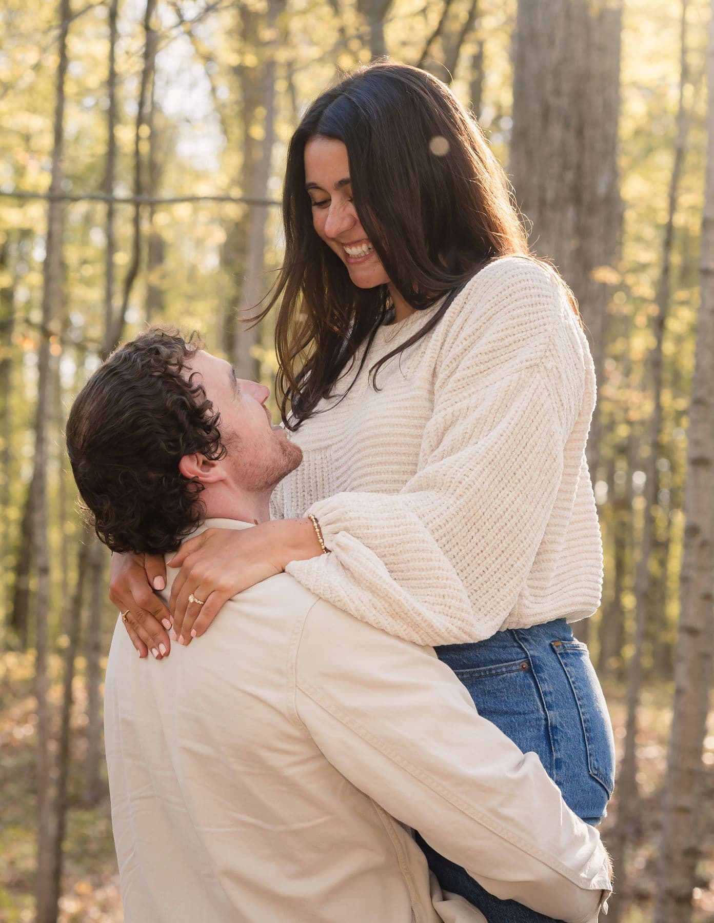 A couple celebrating their engagement in the forest
