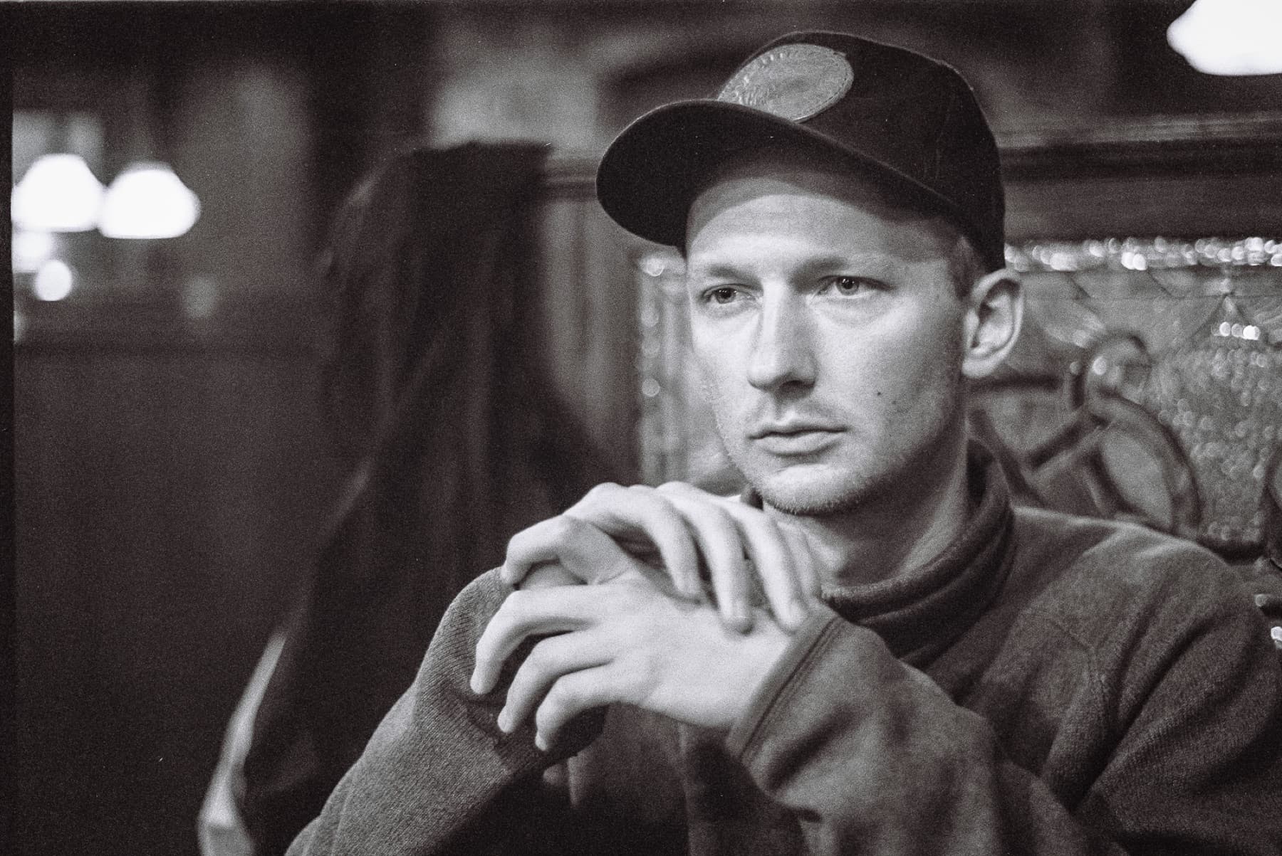 film photo man staring contemplatively at bar