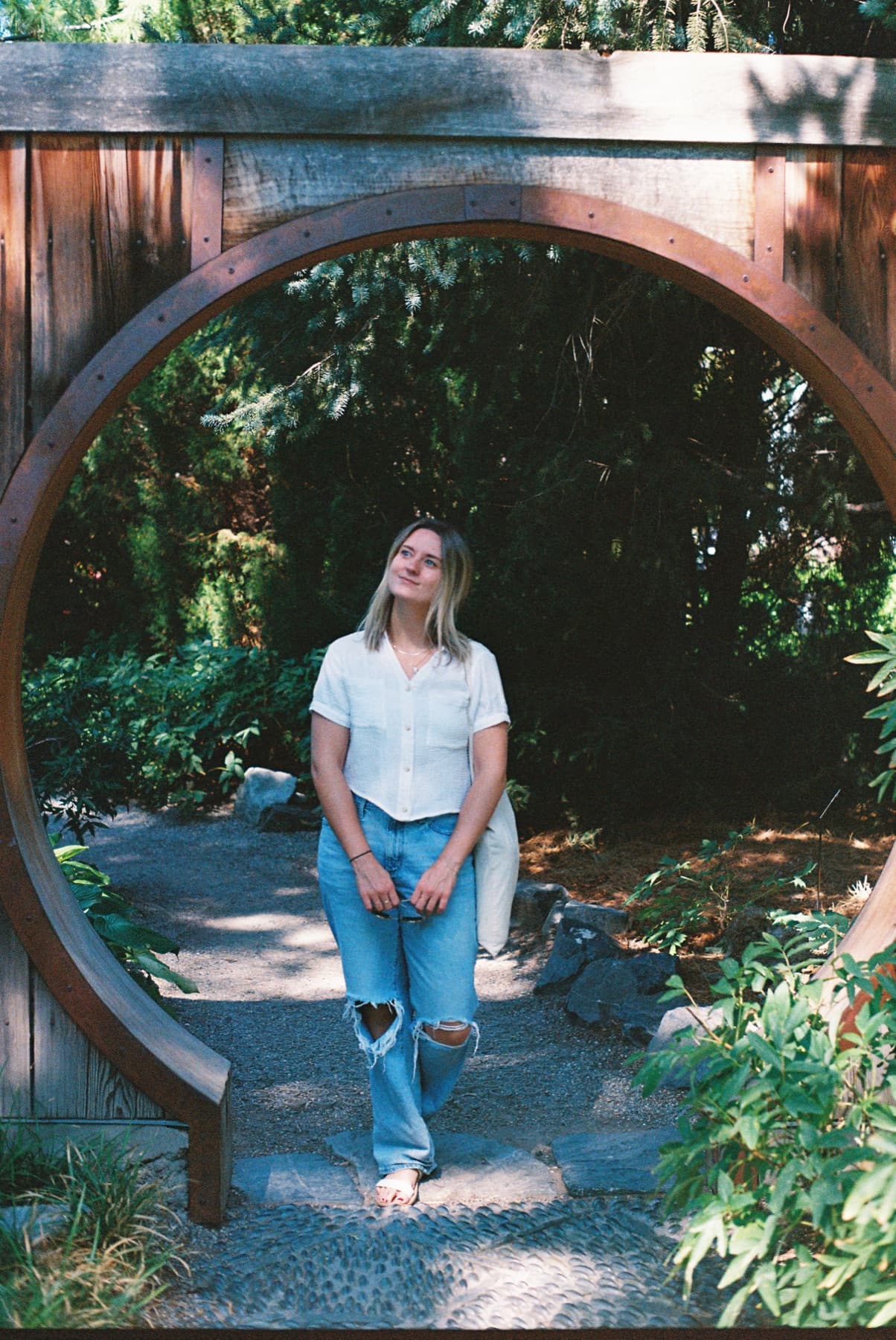 film photo woman in denver botanical gardens under arch