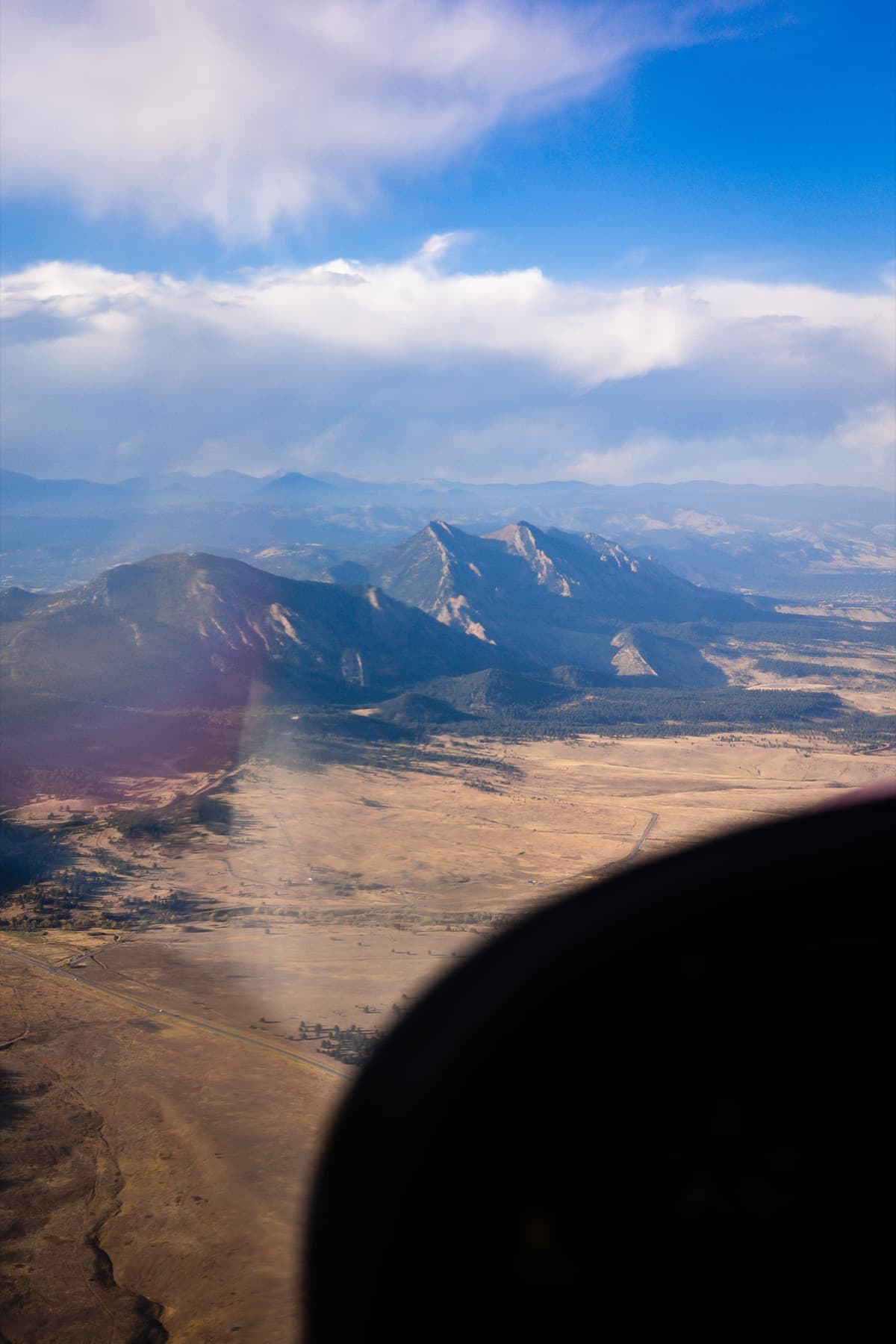 shot from a small prop plane 10 looking at mountains