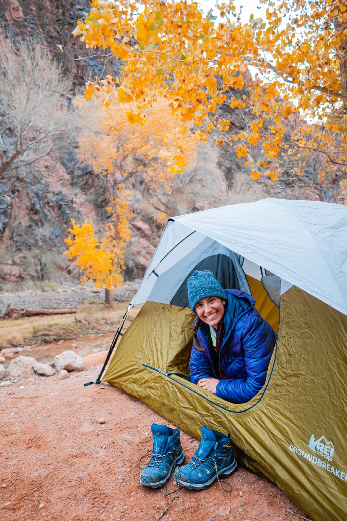 A happy camper smiling from a tent door at the Grand Canyon