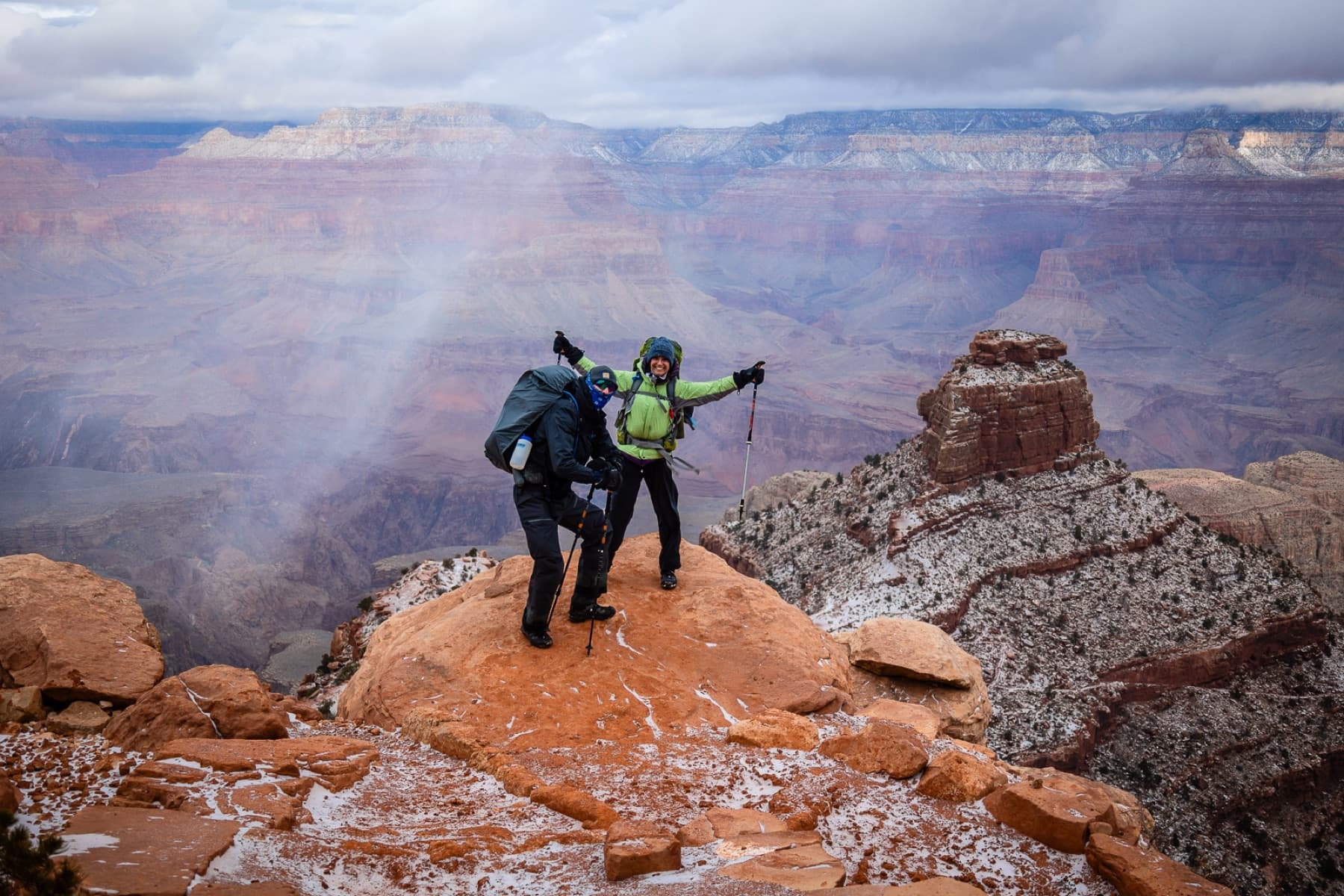 two happy hikers top of grand canyon