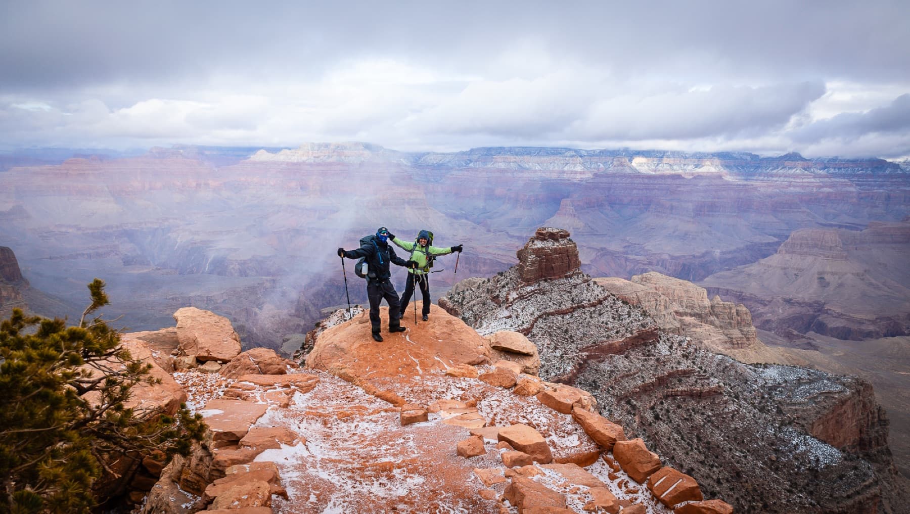 two happy hikers top of grand canyon