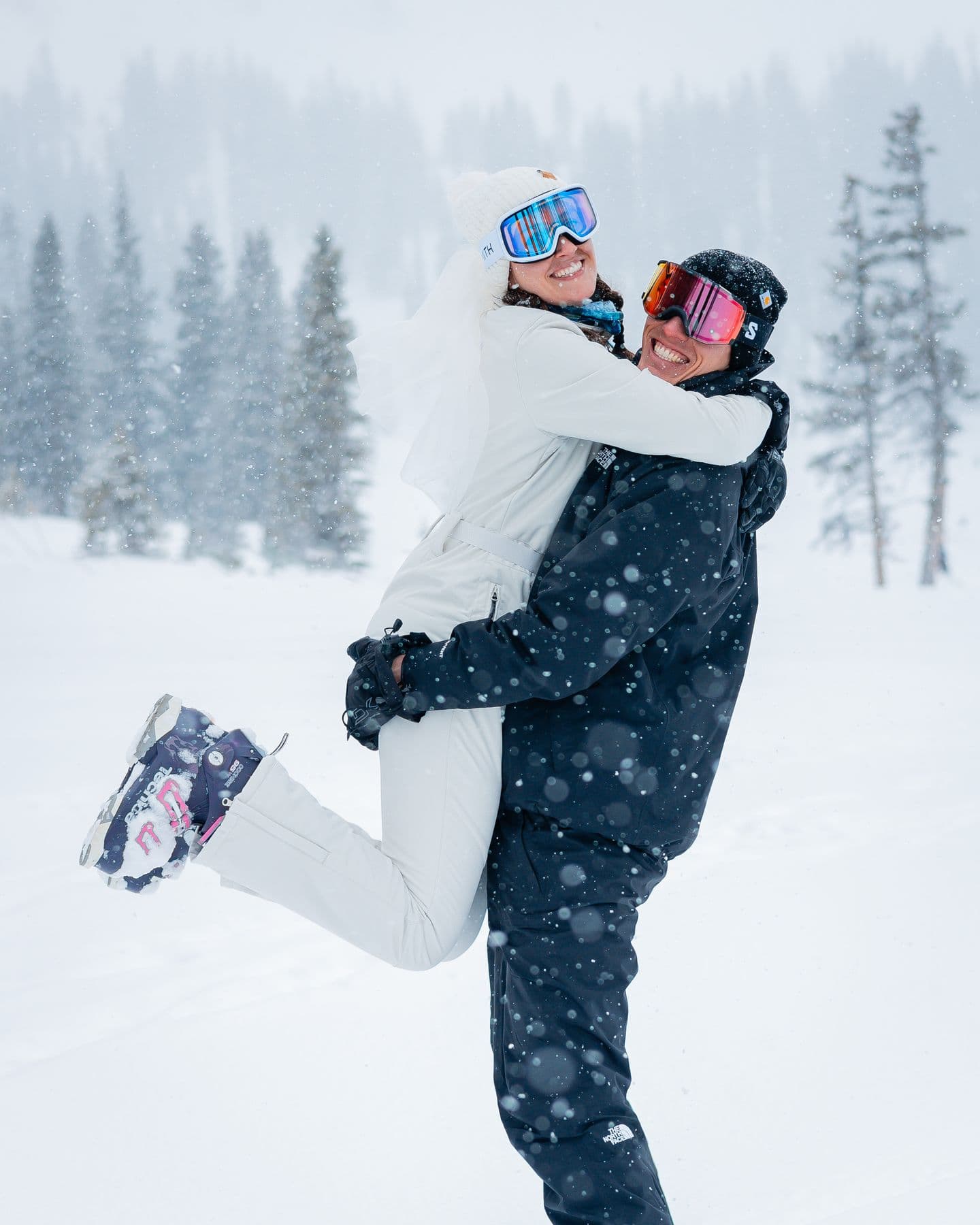 A couple embracing in the snow at their Colorado ski elopement